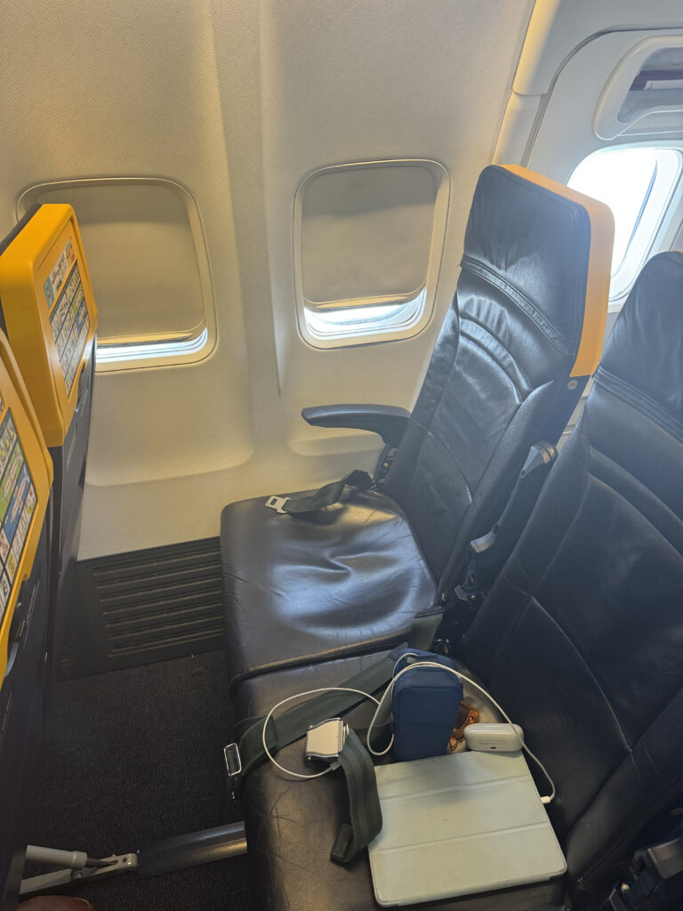 Ryanair aircraft seats are dark blue with yellow plastic around the safety information on the back of each seat.