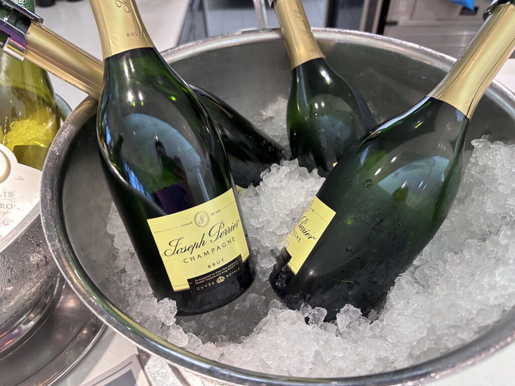 A few bottles of Champagne in an ice bucket.