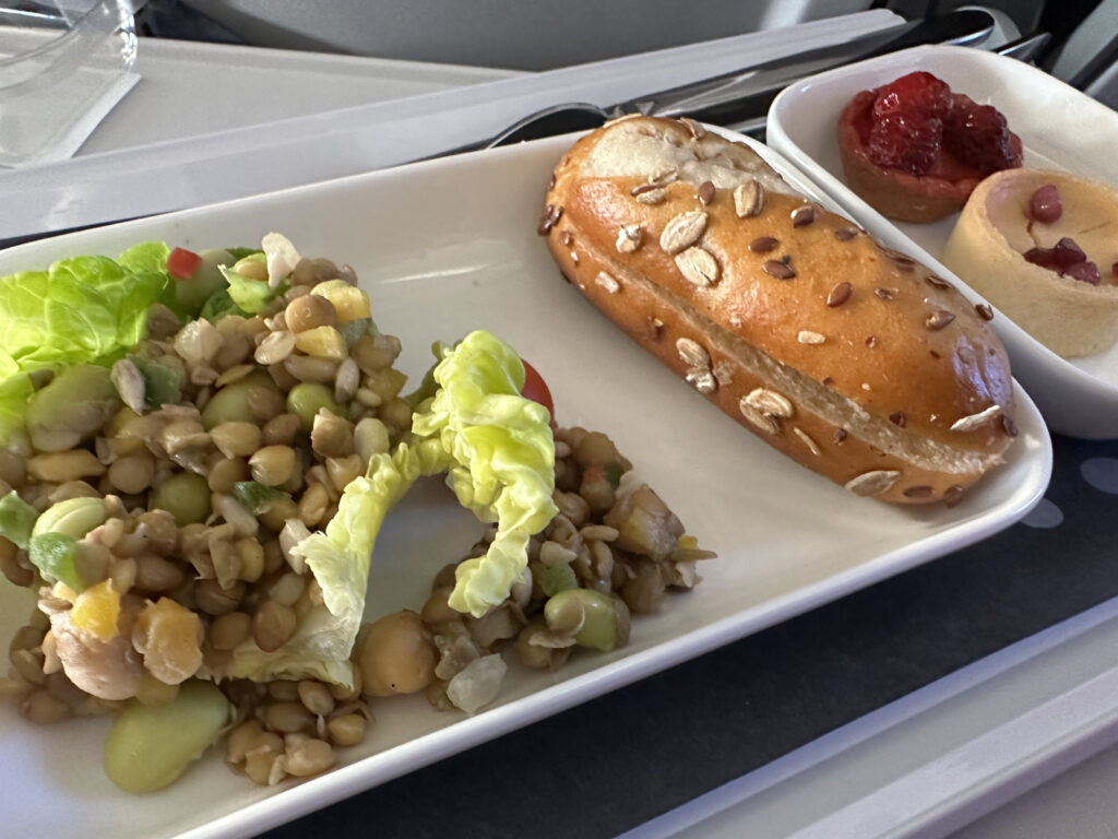 Grain salad with a side roll plus a dessert.