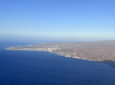 A view from the aircraft overlooking Gran Canaria and the crystal blue ocean.