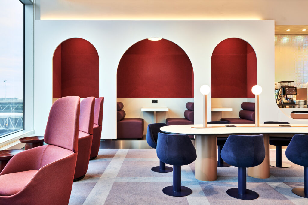 Arches line the back of the oneworld alliance's European lounge in Amsterdam Airport Schiphol. Rich reds and blues accent the light walls.