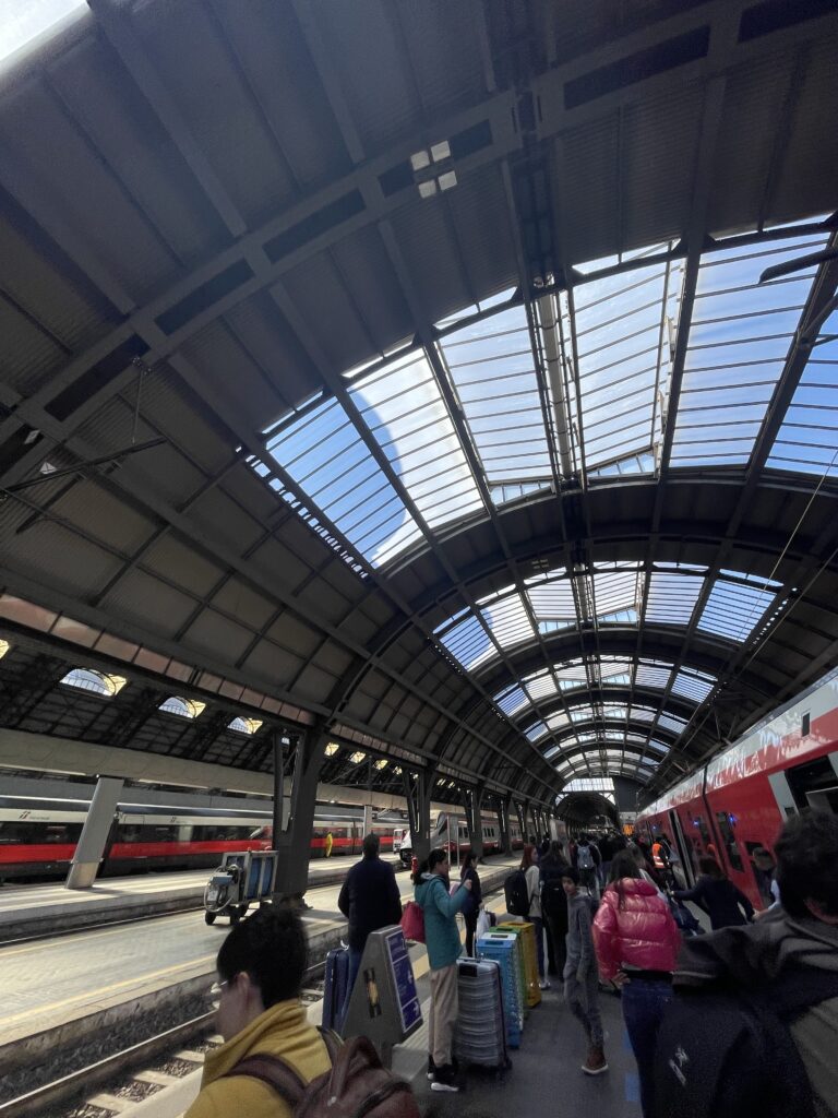 A busy platform of passengers at the Milano Centrale train station