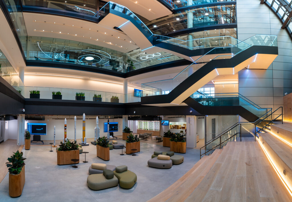 A large open space in the ViaSat's new building with a large staircase connecting every floor.