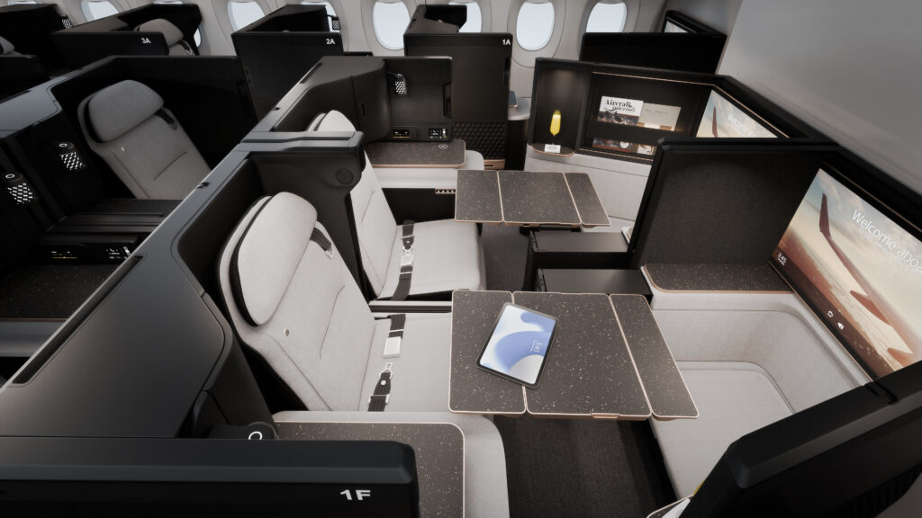 A rendering of the Safran Unity Elite business class seat. The all white seat gives a luxurious atmosphere with black trim. Tray tables are large.