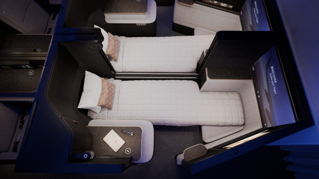 A rendering of the Safran Unity Elite business class seats in bed mode. The all white seat gives a luxurious atmosphere with black trim and blue LED Lighting. Two seats are in bed mode here.