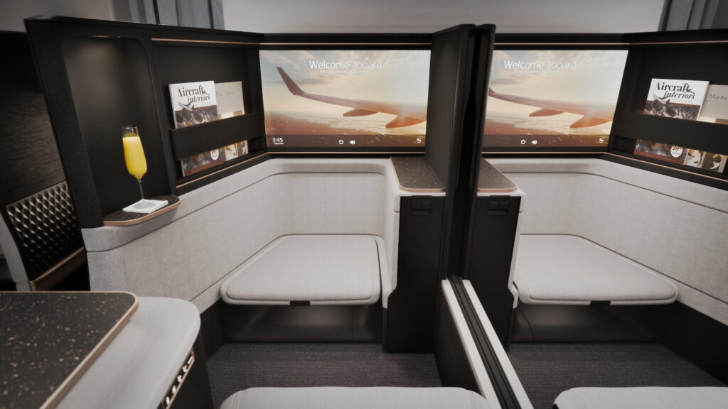 Looking at two large IFE screens in a rendering of the Safran Unity Elite business class seat. Ample footwells are in view.