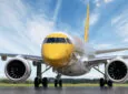 Scoot Embraer E190 sports a yellow noes and tail with a white body.