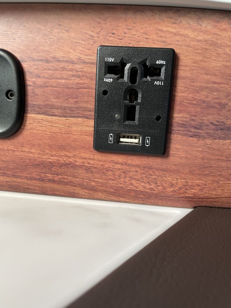 A close up of the in-seat power, both AC and USB-A.