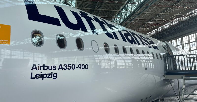 Lufthansa A350-900 at the hangar in Munich. The aircraft is called Leipzig, which is painted on the side under the word Lufthansa in blue against a white backdrop.