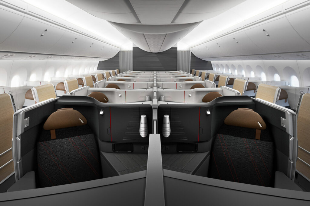 American Airlines business class cabin in greys and browns. Subtle red stripes are seen throughout the cabin design