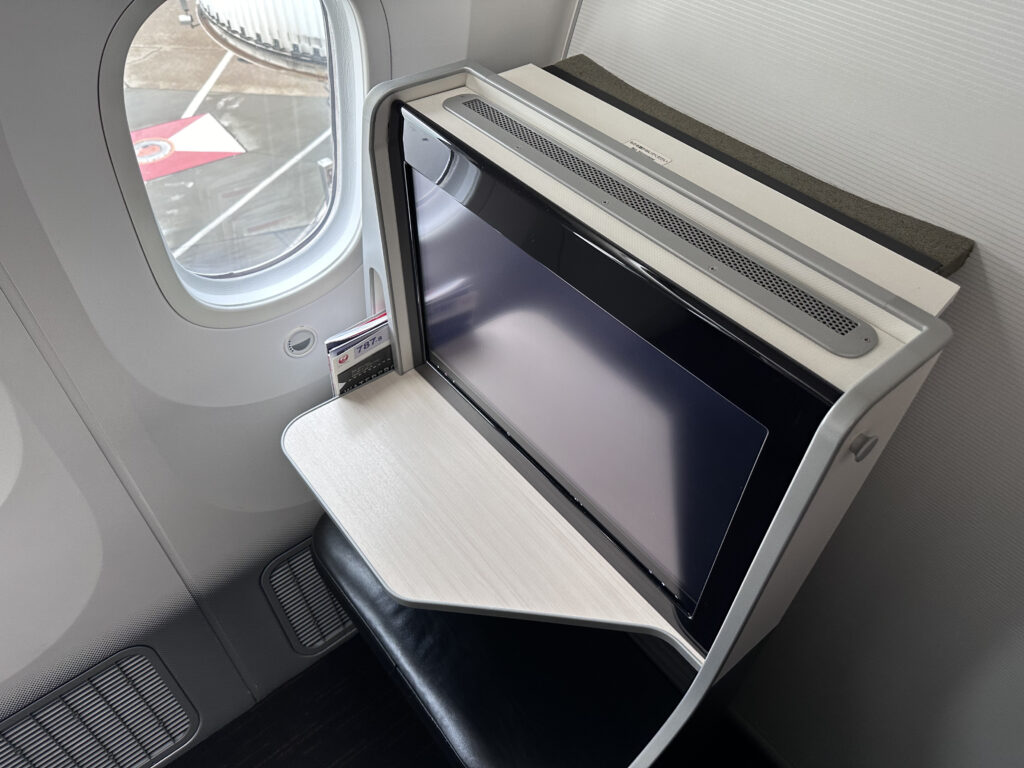 Looking down on the seat's large IFE screen and footwell. 