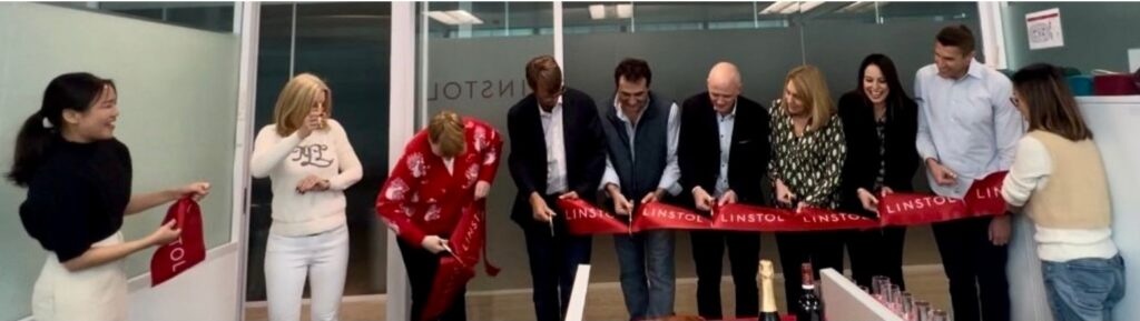 Several execs cut a ribbon to indicate the new Linstol Hong Kong office is now open.