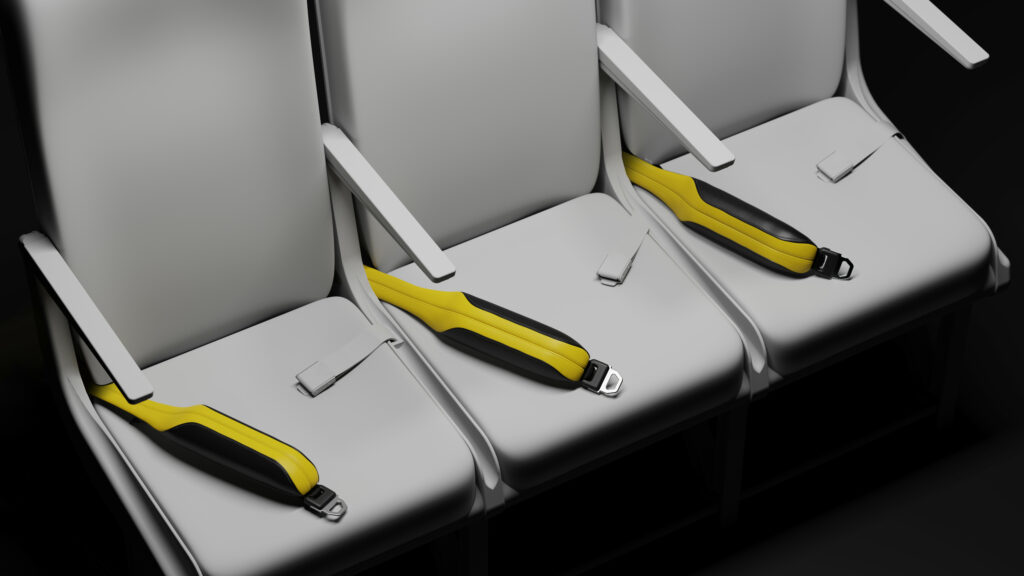 AirPRO by Schroth Safety Products is a yellow and black lap belt with integrated airbag and crash sensor tech laid out on a grey aircraft seat. 