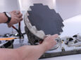 Satcom Direct Plane Simple® Ka-band terminal is pictured in a man's hands.