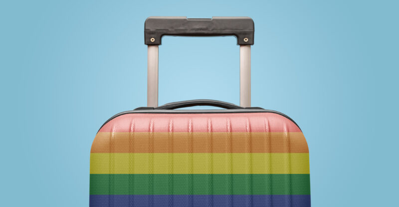 Luggage with LGBTQ+ pride colors against a light blue backdrop. Diversity, equity and inclusion