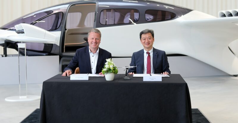Execs at a table in front of the eVTOL: Lilium signing a collaboration agreement with the Shenzhen-based Bao’an District