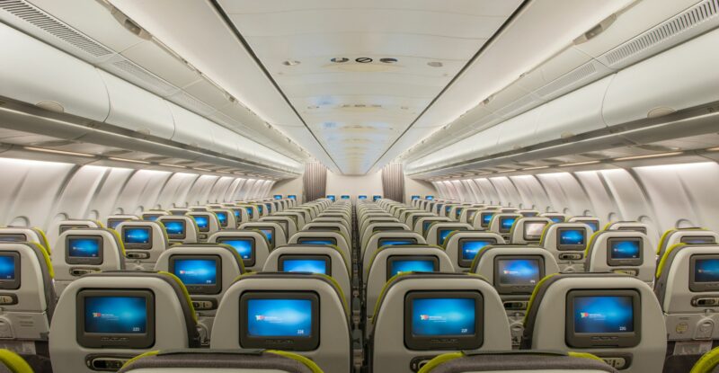 TAP A330 economy class cabin from the back showing all of the seats have embedded IFE