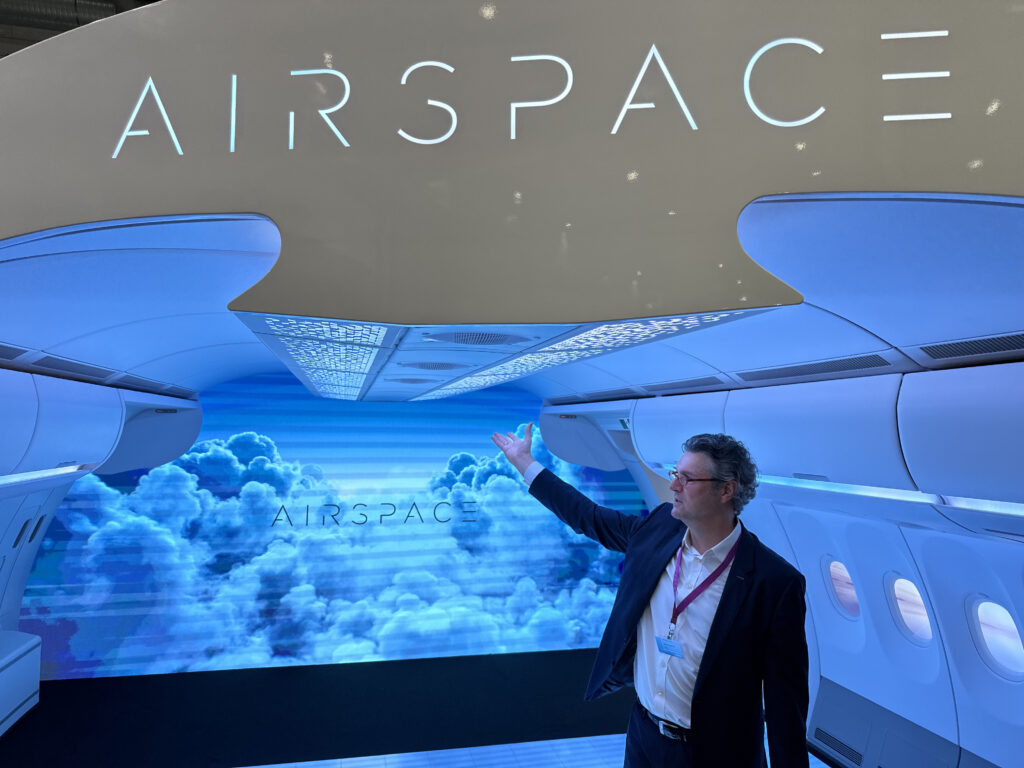 Wuggetzer presents the Airbus A330neo cabin display at AIX 2024. The cabin is accented with blue LED lights and cloud like imagery
