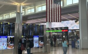 Passengers watch the screens at Newark Liberty