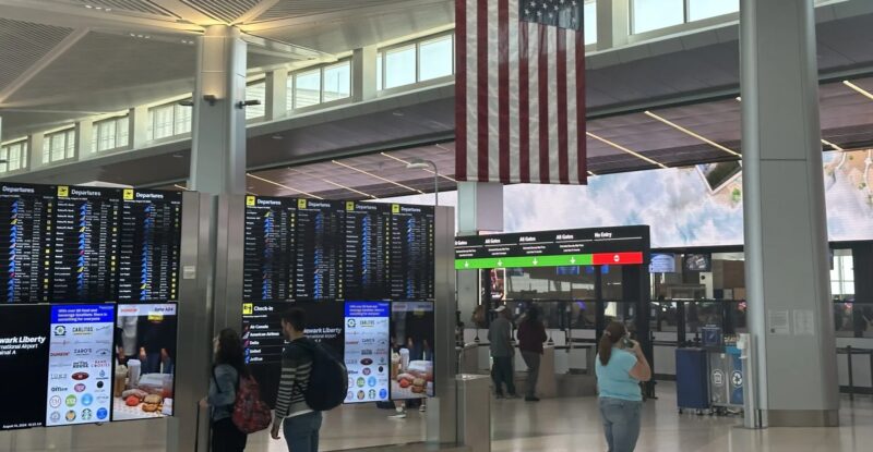 Passengers watch the screens at Newark Liberty