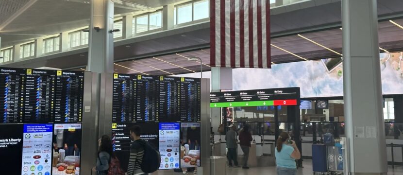 Passengers watch the screens at Newark Liberty