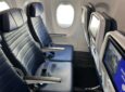 A seat triple on a United Airlines 737 MAX 8 with the IFE screens in view. United and DISH have inked an agreement to bring live sports to passengers during football season.