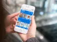 ITA Airways' app with Media Carrier's digital titles displayed on a mobile device.