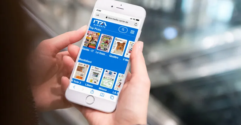 ITA Airways' app with Media Carrier's digital titles displayed on a mobile device.