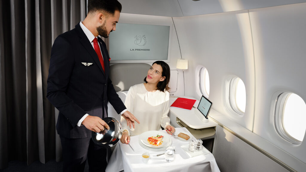 Woman passenger enjoys a first class dining experience aboard the Air France 777.