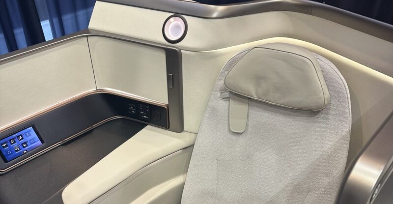 Recaro Aircraft Seating R7 platform in cream CMF on the Recaro stand at AIX 2025