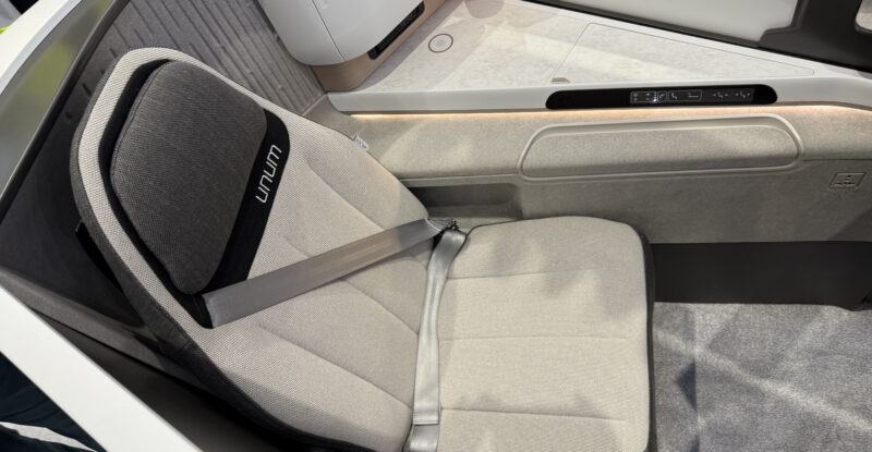 Unum One business class seat on the show floor at AIX 2025