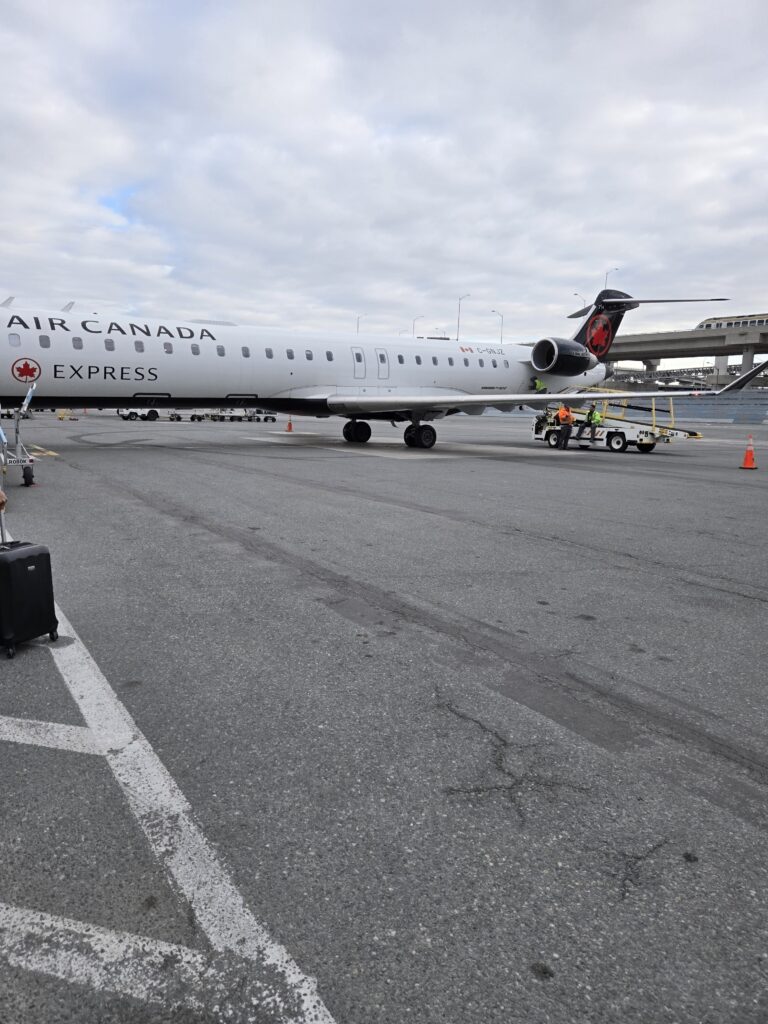 Air Canada CRJ900 parked and ready to board. The slim antenna can just about be seen on the jet.
