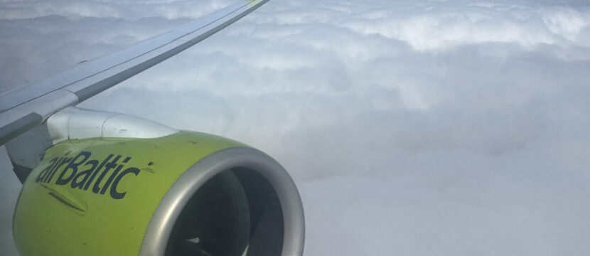 Engine and wing of airBaltic A220, in the carrier's signature green, as seen through a cabin window on this Brussels Airlines flight.