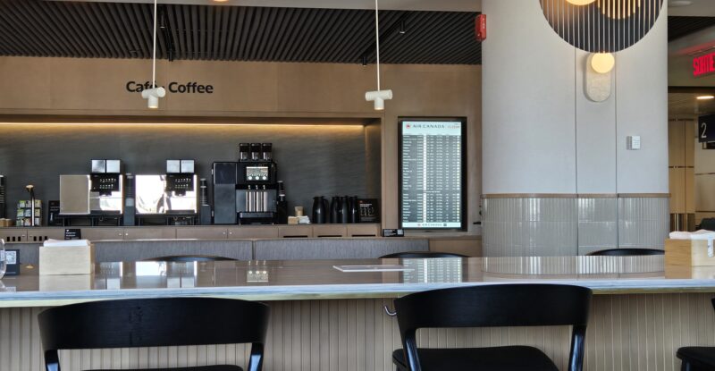 Air Canada Café lounge in Montreal with stools against a bar.