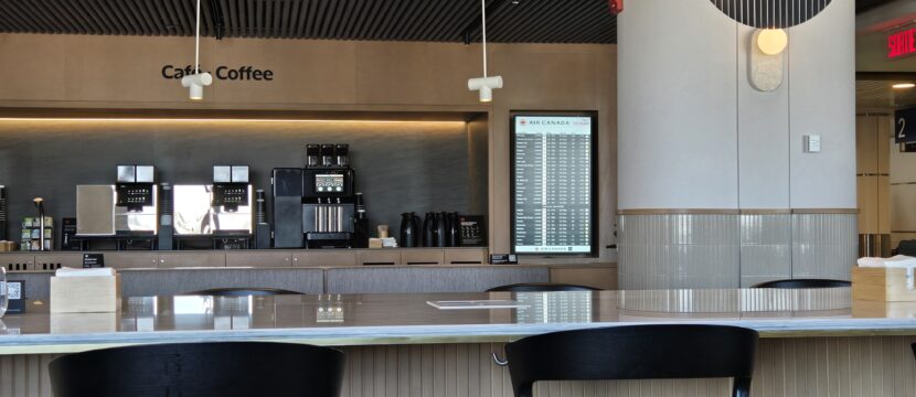Air Canada Café lounge in Montreal with stools against a bar.