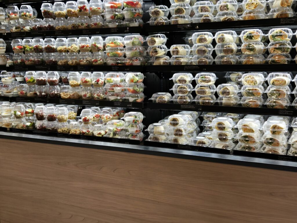 A wall of pre-made salads and sandwiches in Air Canada Café