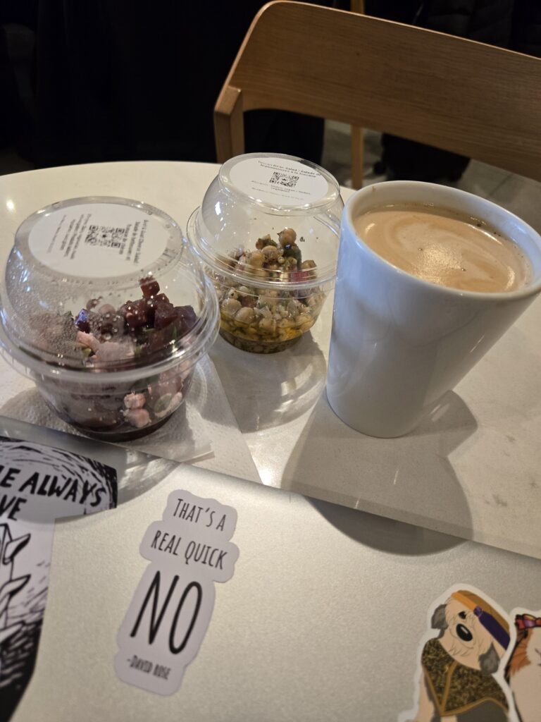 A latte and some food items on a table