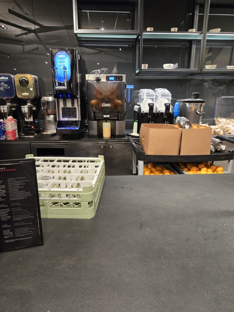 The bar with a close up of the fresh orange juice machine in the Air Canada Café