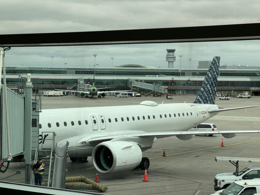 Porter Embraer E195-E2 at the gate with IFC clearly fitted to the aircraft as evidenced by the radome on top of the fuselage.