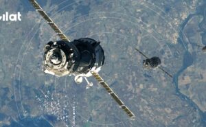 A satellite over the earth with Gilat logo to the upper left