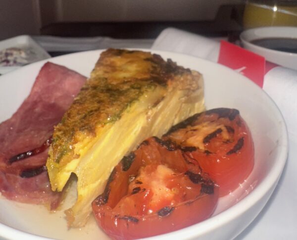 Close up of quiche breakfast with tomatoes and bacon
