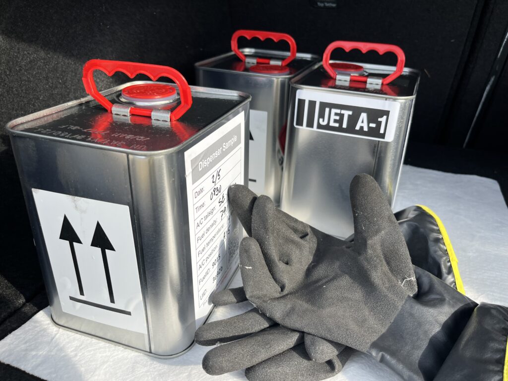 Three jet fuel canisters sit on a table. As part of the ALIGHT project, stakeholder are studying their properties in relation to emissions. 