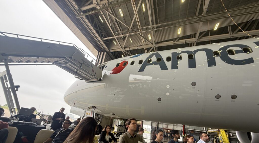 American 787-9 in the hangar in Fort Worth, with people all around it, waiting for the big reveal.