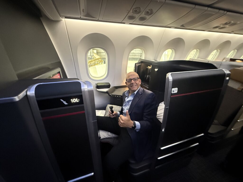 The author, Chris Sloan, smiling in an American Airlines Flagship Preferred suite.