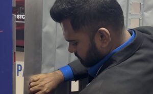 Amsafe Bridport staffer demonstrates the company's new secondary cockpit barrier for commercial aircraft.