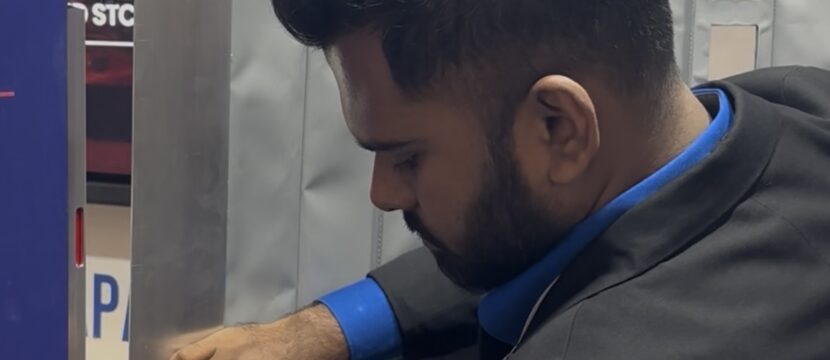 Amsafe Bridport staffer demonstrates the company's new secondary cockpit barrier for commercial aircraft.