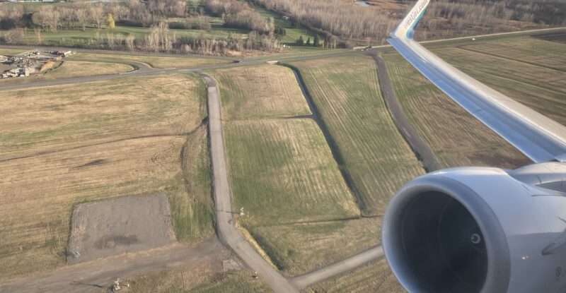 WestJet 737 engine and wing as seen out the window.