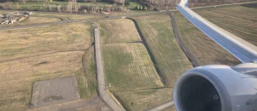 WestJet 737 engine and wing as seen out the window.