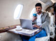 A male passenger is using Viasat JetXP in flight