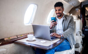 A male passenger is using Viasat JetXP in flight
